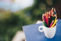 Colored pencils in a glass on Bokeh background Royalty Free Stock Photo