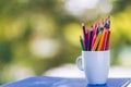 Colored pencils in a glass on Bokeh background Royalty Free Stock Photo