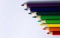 Colored pencils laid out in a row like a rainbow. Royalty Free Stock Photo