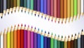 Colored pencils laying in a row. Wave frame made by pencil tips. Royalty Free Stock Photo