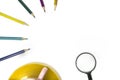 colored pencils lie in a half circle , on and magnifier isolated white background. Copy space. Royalty Free Stock Photo