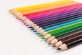 Colored pencils in line on white background