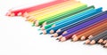 Colored pencils lying in irregular row Royalty Free Stock Photo