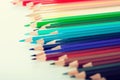 Colored pencils lying in irregular row Royalty Free Stock Photo