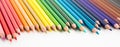 Colored pencils lying in irregular row Royalty Free Stock Photo