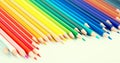 Colored pencils lying in irregular row Royalty Free Stock Photo
