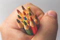 Colored pencils in male hand