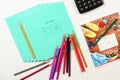 colored pencils and notebooks diary lie on a white wooden table Royalty Free Stock Photo