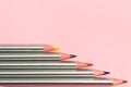 Colored pencils on pastel pink background. Trend colors, Pattern.Multi-colored wooden pencils with silvery coating Royalty Free Stock Photo