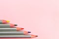 Colored pencils on pastel pink background. Trend colors, Pattern.Multi-colored wooden pencils with silvery coating Royalty Free Stock Photo