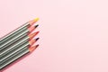 Colored pencils on pastel pink background. Trend colors, Pattern.Multi-colored wooden pencils with silvery coating. Royalty Free Stock Photo