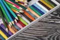 Colored pencils and pastels for drawing.  They lie on pine boards.  Top view Close-up Royalty Free Stock Photo