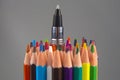 Colored pencils and pen for drawing on a gray background. Education and creativity. Leisure and art Royalty Free Stock Photo