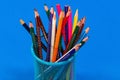 Colored pencils in a pencil case on blue background with copy sp Royalty Free Stock Photo