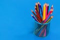 Colored pencils in a pencil case on blue background with copy sp Royalty Free Stock Photo