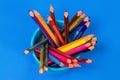 Colored pencils in a pencil case on blue background, top view Royalty Free Stock Photo