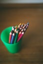 Colored pencils in pencil case on wooden background. Selective focus. Royalty Free Stock Photo