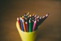 Colored pencils in pencil case on wooden background. Selective focus. Royalty Free Stock Photo