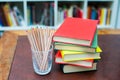 Colored pencils with pile of books with colored covers Royalty Free Stock Photo