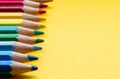 Colored pencils in Rainbow colors in a row on orange background, retro modern design space for text Royalty Free Stock Photo