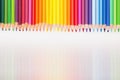 Colored pencils in rainbow order on white background. Royalty Free Stock Photo