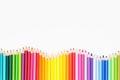 Colored pencils in rainbow order on white background. Royalty Free Stock Photo