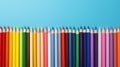 colored pencils in a row on a blue background with copy space, top view, flat lay, teacher\'s day promotion horizontal banner Royalty Free Stock Photo