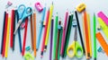 Colored pencils, scissors, notebook, ruler, pen, eraser, sharpener and more in glass. School and office stationery on light blue Royalty Free Stock Photo