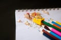 Colored pencils, sharpener and shavings Royalty Free Stock Photo