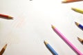 Colored pencils on a sheet of white paper. Royalty Free Stock Photo