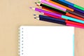 Colored pencils, sketchbook on a craft background. School or education theme concept. Top view, flat lay, place for text, copy Royalty Free Stock Photo