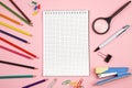 Colored pencils, stationery, paper notebook with pen and magnifier on pink isolated background. top view. flat lay. mockup Royalty Free Stock Photo