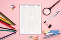 Colored pencils, stationery, paper notebook with pen and magnifier on pink isolated background. top view. flat lay. mockup Royalty Free Stock Photo