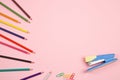 Colored pencils and stationery on pink isolated background. top view. flat lay. mockup Royalty Free Stock Photo