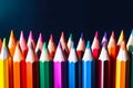 colored pencils with their tips pointed upwards on dark background. banner with copy space, template, cover, background Royalty Free Stock Photo