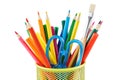Colored pencils and various stationery in a holder. Isolated Royalty Free Stock Photo