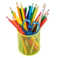 Colored pencils and various stationery in a holder. Isolated Royalty Free Stock Photo