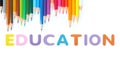 Colored pencils wave with alphabet sponge rubber of text `EDUCATION` over white background Royalty Free Stock Photo