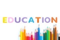 Colored pencils wave with alphabet sponge rubber of text `EDUCATION` over white background Royalty Free Stock Photo