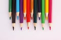 Colored pencils on a white background in staggered order. Lots of different colored pencils. Colored pencil. Pencils are sharp. Royalty Free Stock Photo