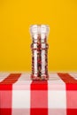 Colored Peppers Mix and pepper grinder on yellow background