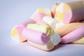 Colored pieces of marshmallow stacked on a white background