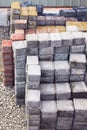 Colored piles of concrete paving slab outdoors.