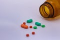 Colored pills. Legal drugs. Medications for humans. Brown glass container