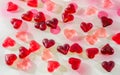 Colored (pink, red and orange), transparent heart shape jellies, colored degradee background Royalty Free Stock Photo