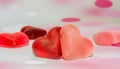 Colored (pink, red and orange), transparent heart shape jellies, colored degradee background Royalty Free Stock Photo