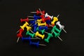 Colored pins on a black background. Royalty Free Stock Photo