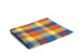 Colored plaid folded fabric isolated, plaid kitchen towel, picnic decoration element Royalty Free Stock Photo