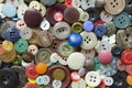 Colored plastic buttons on brown wooden background Royalty Free Stock Photo