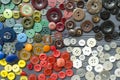 Colored plastic buttons on grey wooden background Royalty Free Stock Photo